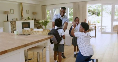 Happy Family Preparing Children for School in Cozy Living Room