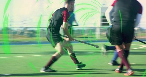 Field hockey players racing across synthetic turf with neon motion rings and dynamic blur