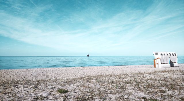 Peaceful beach scene featuring a calm ocean meeting a sandy shore. Suitable for promoting travel destinations, vacation spots, or relaxation activities. Ideal for use in travel brochures, websites, or advertisements highlighting serene and tranquil holiday experiences.