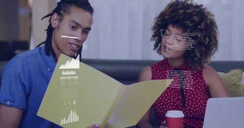 Reviewing project data together with laptop and folder displaying analytics and charts