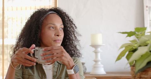 Contemplative Woman Relaxing with Mug in Minimalist Home Setting