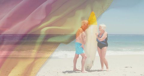 Senior Couple with Surfboard on Sunny Beach Vacation