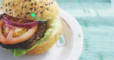 Gourmet Beef Burger with Sesame Seed Bun, Tomato and Red Onion on White Plate