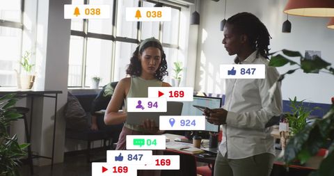 Diverse Coworkers Discussing Digital Strategy in Modern Office