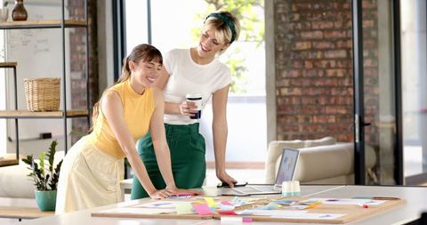 Female Coworkers Collaborating in Modern Office Loft