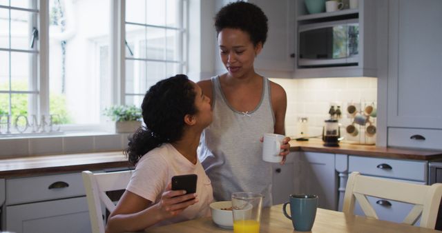 Women enjoying casual morning in modern kitchen with breakfast and coffee - Download Free Stock Images Pikwizard.com