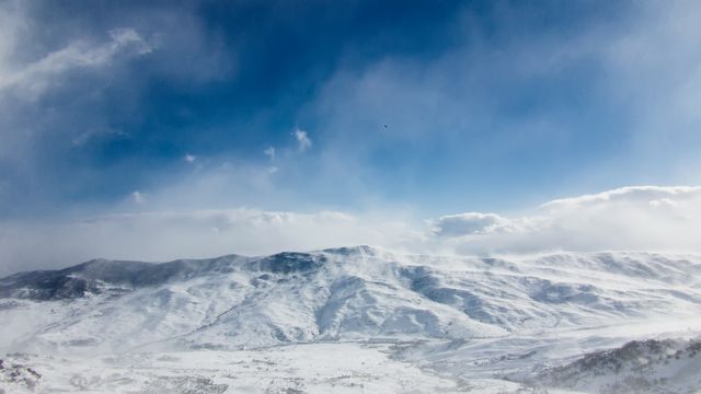 Snow-covered mountain range under blue sky in winter - Download Free Stock Photos Pikwizard.com