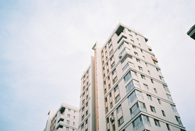 Low Angle View of Modern High-Rise Residential Buildings Against Clear Sky - Download Free Stock Photos Pikwizard.com