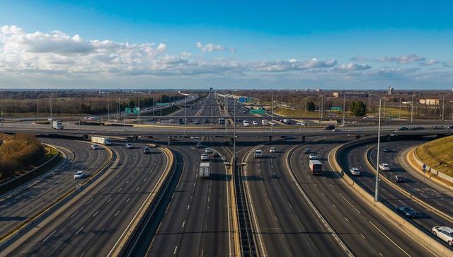 Aerial showcasing sprawling highway interchange with curving ramps and mixed traffic