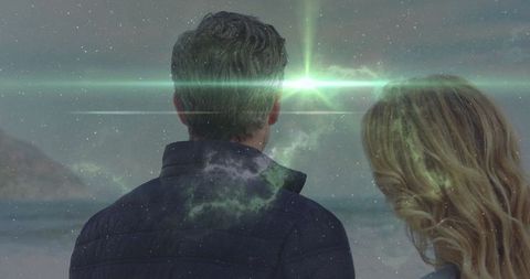 Couple on shore infused with cosmic dreamscape