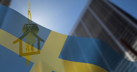 House key on swedish flag with urban background