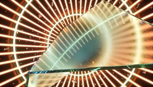Triangular glass prism refracting warm concentric light rings with cyan rim and shards