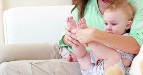Mother and Baby Playing on Cozy White Sofa Moment - Download Free Stock Images Pikwizard.com
