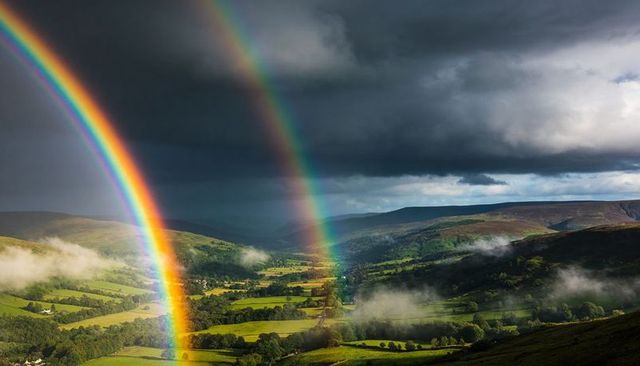 Double Rainbow Arching Over Misty Valley, Illuminating Patchwork Fields and Moorland