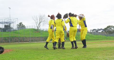 Female athletes celebrating on softball field