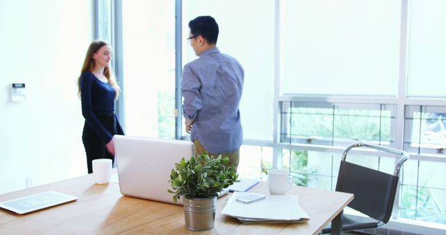 Colleagues Talking by Office Window - Download Free Stock Images Pikwizard.com