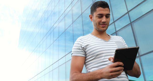 Young Man Using Tablet in Urban Setting - Download Free Stock Images Pikwizard.com