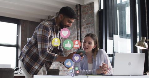 Colleagues Engaging with Social Media Icons in Modern Office