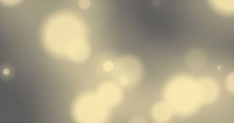 Mystical yellow bokeh light against grey backdrop