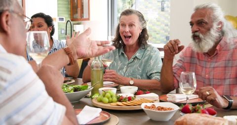 Senior Friends Celebrating and Enjoying Dinner Together