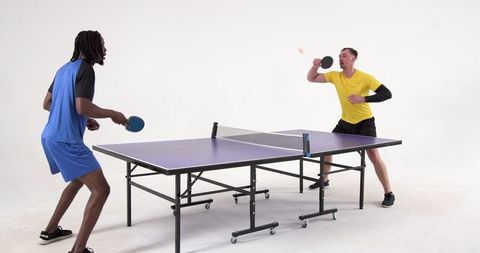 Energetic Table Tennis Players Competing in Dynamic Studio Match
