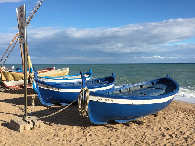 Traditional Fishing Boats on Sandy Beach with Clear Blue Sky - Download Free Stock Photos Pikwizard.com