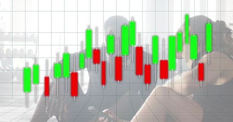 Business team discussing mobile trading data with candlestick chart overlay in office