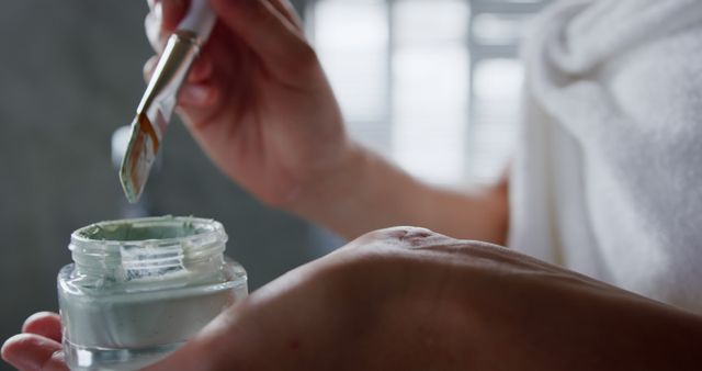 Woman Applying Facial Mask with Brush for Skincare Routine - Download Free Stock Images Pikwizard.com