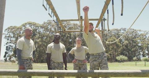 Diverse soldiers engaging in boot camp training outdoors