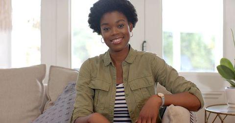 Mid adult woman relaxing on sofa at home in stylish living room