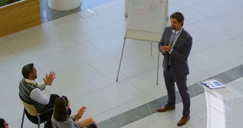 Business speaker engaging audience in corporate seminar