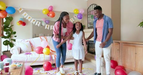 Family Birthday Celebration with Balloons and Confetti at Home