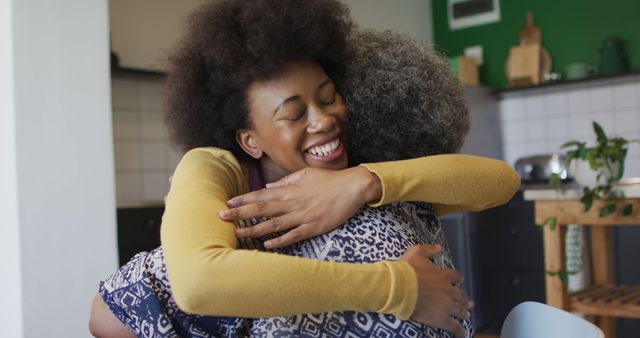 Joyful Reunion Between Mother and Daughter Hugging in Modern Kitchen - Download Free Stock Images Pikwizard.com