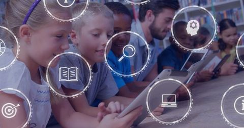 Elementary students and teacher using tablets in library, collaborative digital learning