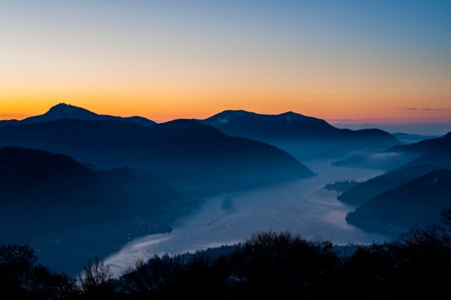 Calm Twilight Over Serene Lake and Mountain Range - Download Free Stock Photos Pikwizard.com