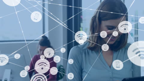 This video depicts a woman using a digital tablet with overlaid network icons, symbolizing connectivity and technological interaction in a modern office. It can be used for promoting business technology, highlighting advancements in wireless communications, or illustrating digital innovation in environments focusing on contemporary workplace solutions.