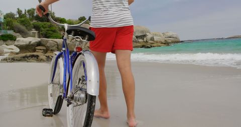 Man Walks Bicycle on Scenic Beach Backdrop - Download Free Stock Images Pikwizard.com