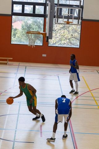 Basketball Players in Action on Indoor Court