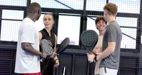 Diverse Young Athletes on Padel Court with Rackets