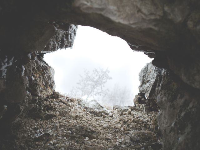 Glimpse of Misty Landscape through Rocky Cave Opening - Download Free Stock Photos Pikwizard.com