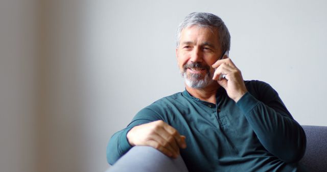 Smiling Mature Man Talking on Smartphone at Home - Download Free Stock Images Pikwizard.com