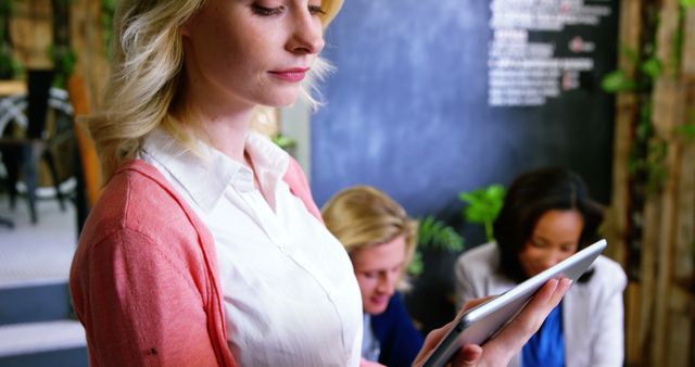 Young Businesswoman Using Digital Tablet in Modern Office Environment - Download Free Stock Images Pikwizard.com