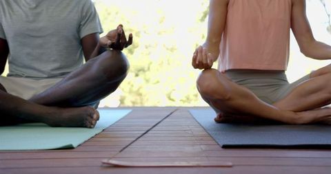 Diverse Couple Meditating on Yoga Mats with Burning Incense