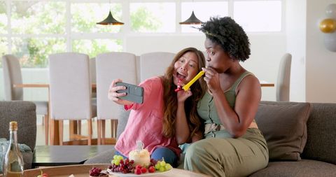 Happy Lesbian Couple Celebrating Birthday with Selfie and Snacks