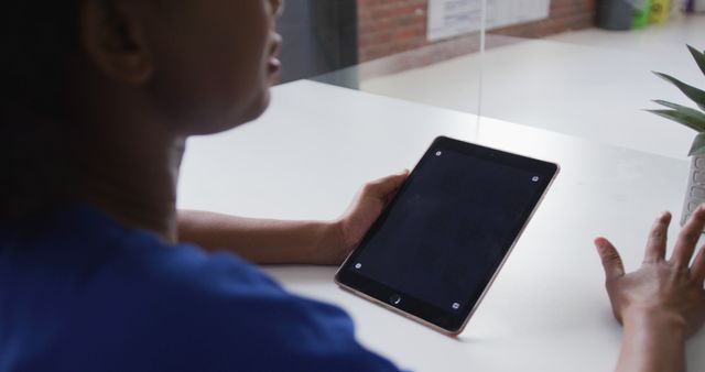 Woman in Blue Shirt Holding Tablet at Desk - Download Free Stock Images Pikwizard.com