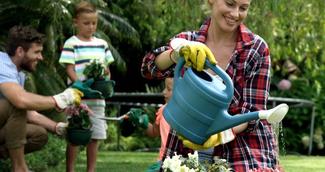 Family Gardening Together Smiling Caring for Plants Outdoors - Download Free Stock Images Pikwizard.com