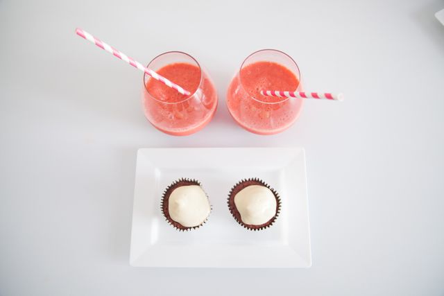 Top View of Strawberry Smoothies with Cupcakes on White Background - Download Free Stock Photos Pikwizard.com