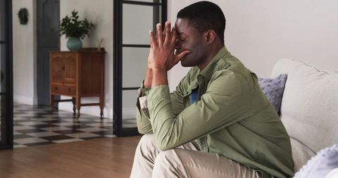Pensive Young Man Reflecting at Home Interior