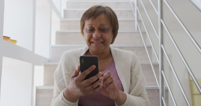 Senior Woman Using Smartphone on Staircase - Download Free Stock Images Pikwizard.com
