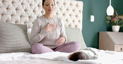 Mother Meditating Near Sleeping Infant for Mindful Parenting Moment